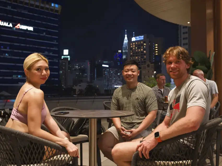 Guests seated at Crafty's with the city lights behind them