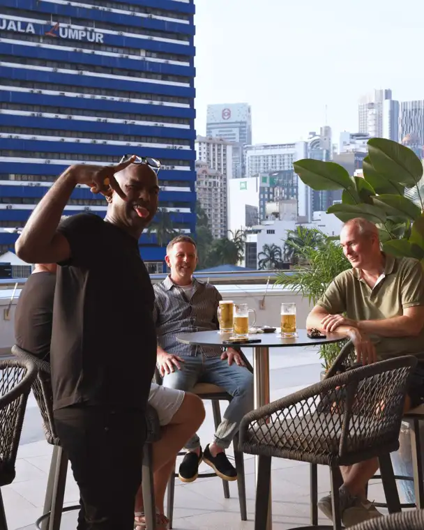 A catch-up with Kuala Lumpur in the background.